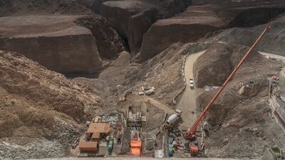 Cranes surround the powerhouse containing the turbines, while heavy machinery and vehicles were being used for backfilling the area