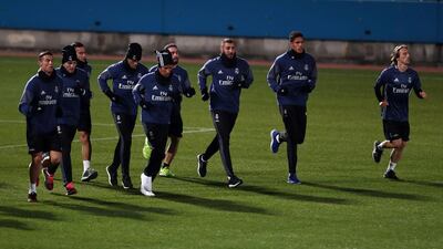 Cristiano Ronaldo, Luka Modric, Raphael Varane, Karim Benzema and others run during a training session. Behrouz Mehri / AFP