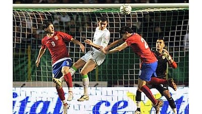 Serbia, in red, and Algeria players fight for the ball.