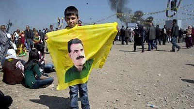 A Kurdish boy holds a banner of Abdullah Ocalan, the jailed leader of the PKK at Newroz festivities in Diyarbakir.