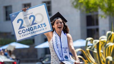 A US graduate from California State University San Marcos celebrates while participating in a car parade through campus. Reuters