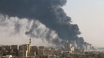 A general view shows rising smoke from a Syrian regime controlled cement factory, in Aleppo, Syria. Abdalrhman Ismail / Reuters