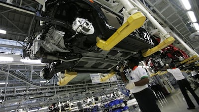 Employees work in a newly inaugurated of Hyundai Motors India auto plant in Sriperumbudur. Dibyangshu Sarkar / AFP