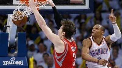 Houston Rockets' Omer Asik dunks in front of Oklahoma City Thunder's Russell Westbrook.