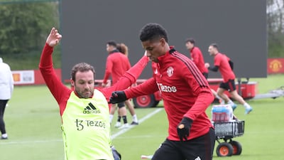 Juan Mata and Marcus Rashford compete for the ball.