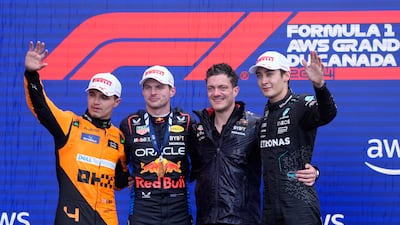 Verstappen celebrates alongside runner-up Lando Norris and third-placed George Russell. Reuters