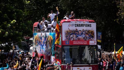 Sri Lanka's Twenty20 cricket team that won the Asia cup championship ride on an open bus after their arrival in Colombo, Sri Lanka, Tuesday, Sept. 13, 2022. (AP Photo / Eranga Jayawardena)