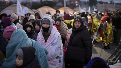 People who fled Ukraine wait for transport after crossing the border into Poland. AP