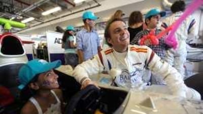 Giedo Van Der Garde, a GP2 race car driver, shows Noor Rashid around a race car at the Yas Marina Circuit yesterday.