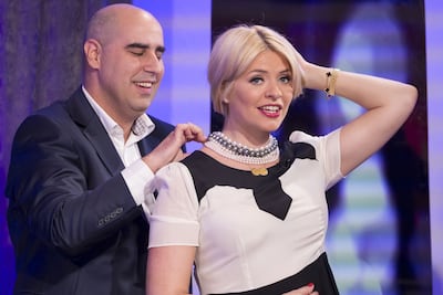 Vashi Dominguez putting a diamond necklace on Holly Willloughby, the presenter of UK television show This Morning. Photo: Shutterstock