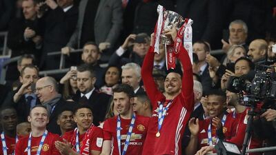 Zlatan Ibrahimovic lifts the League Cup alongside Manchester United teammate Michael Carrick. Kirsty Wigglesworth / AP Photo