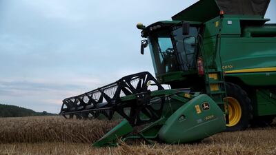 A John Deere combine harvester is seen harvesting winter wheat in a field in the UK. Reuters
