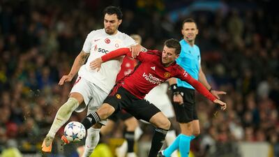 Galatasaray's Kaan Ayhan, left, fights for the ball with Manchester United's Mason Mount. AP