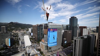 Slackliner Jaan Roose completes South Korea's first highline slackline performance across Seoul city centre. Getty Images