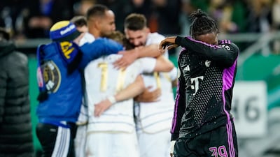Mathys Tel, right, walks past celebrating Saarbruecken after Bayern Munich's German Cup defeat on November 1, 2023. AP