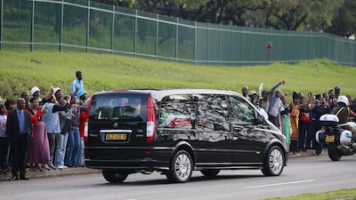 People cheer as the funeral cortege carrying the coffin of former South African President Nelson Mandela leaves the 1 Military Hospital on the outskirts of Pretoria today, on its way to the Union Buildings. Thomas Mukoya / Reuters