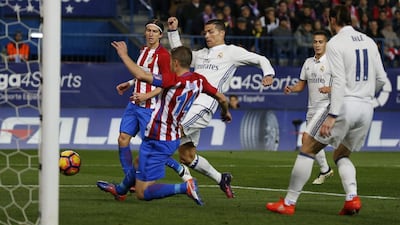 Real Madrid’s Cristiano Ronaldo in action with Atletico Madrid’s Gabi. Javier Barbancho / Reuters
