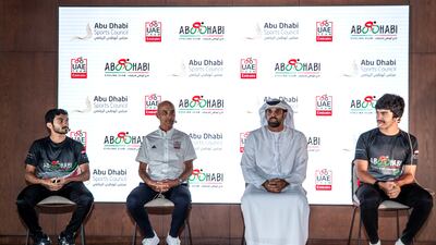 Cyclists Abdullah Al Hammadi and Mohammad Al Mutaiwei with Mauro Gianetti, CEO and team principal of UAE Team Emirates, and Al Nekhaira Al Khyeli, CEO of Abu Dhabi Cycling Club. Victor Besa / The National.