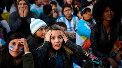 Fans of Argentina watch the World Cup match between Argentina and Croatia on a giant screen at San Martin square in Buenos Aires. Eitan Abramovich / AFP