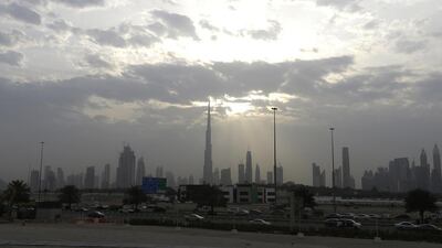 Clouds hug the Dubai skyline as the sun briefly peaks out on Tuesday. Jeffrey E Biteng / The National