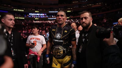 Alex Pereira walks out of the octagon with the middleweight title after defeating Israel Adesanya. Getty