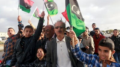 Libyans wave their national flags as they celebrate the internationally-recognised government's gains in Benghazi on February 24, 2016. Esam Omran Al Fetori /Reuters
