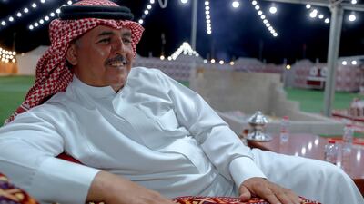 Mohammed Fahd Al Ulayan, 48, from Saudi Arabia relaxes at his tent at the Al Dhafra Festival in Abu Dhabi. Victor Besa / The National