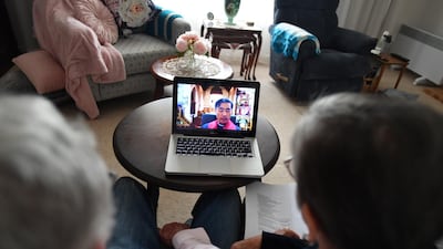 Anglican Parishioner Chris Bowes and her husband Malcolm watch a Good Friday Mass via web broadcast in Adelaide. EPA