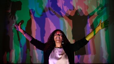 A woman poses with Danish-Icelandic artist Olafur Eliasson's work 'Your Uncertain Shadow' (2010). Photo: EPA