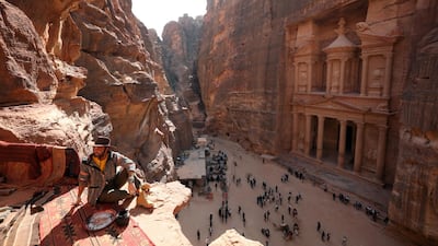 A tourist poses for pictures in front of the treasury site. Reuters