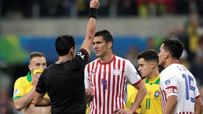 Paraguay's Fabian Balbuena is shown a red card by referee Roberto Tobar. Reuters