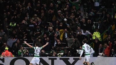 Celtic’s Kieran Tierney, left, celebrates scoring his team’s second goal from a deflection by Manchester City’s Raheem Sterling (unseen). Oli Scarff / AFP