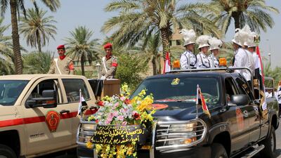 Military vehicles transport the coffins of Maj Gen Abdel Rahman Abu Ragheef and Brig Safeen Abdel Majeed during their funeral ceremonies at the defence ministry in Baghdad on August 27, 2015. Stringer/Reuters