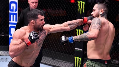 Rodolfo Vieira, left, of Brazil punches Anthony Hernandez in their middleweight fight during the UFC 258 event at UFC APEX in Las Vegas, Nevada. Jeff Bottari / Zuffa LLC / UFC