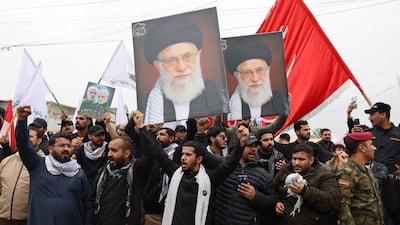 People hold portraits of the slain Iranian supreme leader Ayatollah Ali Khamenei at a funeral in Baghdad for members of Iraq's Popular Mobilisation Forces who were killed in an air strike on their base on March 24, 2026. AFP