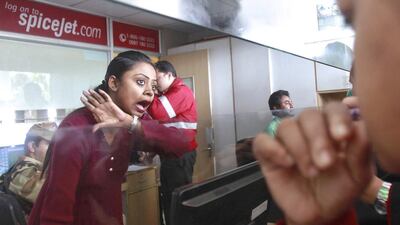 A SpiceJet staff talks to passengers in December 2014 after the budget carrier grounded all flights as oil companies refused to refuel to its fleet of aircraft. Jayanta Dey / Reuters