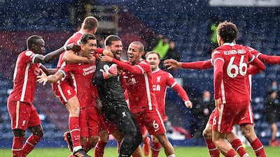 Liverpool goalkeeper Alisson Becker is mobbed by teammates after scoring an injury-time winner against West Bromwich Albion in the Premier League game at The Hawthorns on Sunday, May 16. Reuters