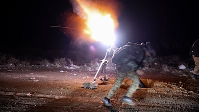 Members of the Syrian Army's artillery battalion target SDF positions with mortar fire in Raqqa. Getty Images