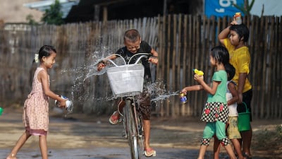 Children douse a child on a bicycle with water to mark the Thingyan Water Festival at Naypyitaw, Myanmar. EPA