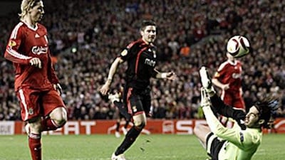 Fernando Torres, left, provides another clinical finish as Liverpool run out 4-1 winners against Benfica at Anfield.