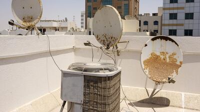 Satellite dishes mounted on the roof of a residential building in the Mohammed bin Zayed City area of Abu Dhabi. By law, a building can only have four dishes or face a fine. Christopher Pike / The National