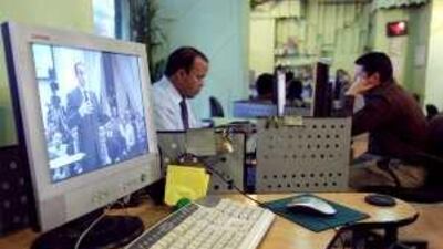 A computer screen in an internet cafe in Cairo shows Gamal Mubarak, son of the Egyptian president Hosni Mubarak, speaking on a streamed video forum.