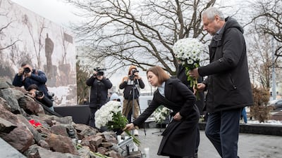 Moldova's President, Maia Sandu, and Minister of Culture, Sergiu Prodan, lay flowers at the Holocaust Memorial in the country's capital, Chisinau. EPA