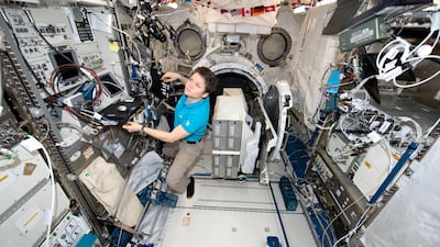 NASA astronaut Anne McClain works inside the Japanese Kibo laboratory aboard the International Space Station.