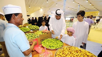 Yousif, 7, picks limes with his father Ibrahim Al Nqbi at the Dried Fish and Fishing Festival in Dibba Al Hisn, Sharjah. All pictures by Chris Whiteoak/The National