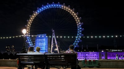 The London Eye illuminated in yellow and blue. Reuters