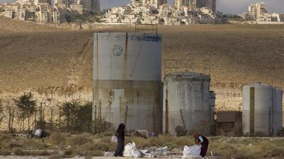 Palestinian women collect scrap timber in the Mishor Adumim industrial zone near the Jewish West Bank settlement of Maaleh Adumim on November 22, 2010. Sebastian Scheiner, File/AP Photo