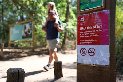 A sign warns visitors of a high risk of fire due to the dry conditions, at Frensham Ponds, near Farnham, south-west of London. AFP