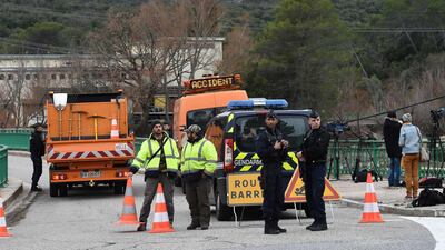 French gendarmes stand guard near the site of an accident near Carces lake, about 50 kilometres northwest of the resort of Saint-Tropez as the road is blocked after two army helicopters crashed into each other. Anne-Christine Poujoulat / AFP