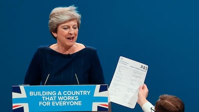 Comedian Simon Brodkin, right, givesBritain's Prime Minister Theresa May her P45 (UK's employee leaving form) during the Conservative Party annual conference in Manchester. Paul Ellis / AFP Photo / October 4, 2017